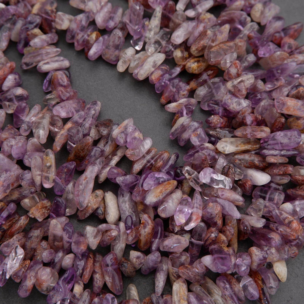 Close-up of purple and brown crystal chips on a dark surface