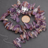 Necklace made of amethyst crystal chips on a gray background