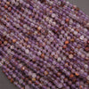 Close-up of purple and brown beads on a gray background