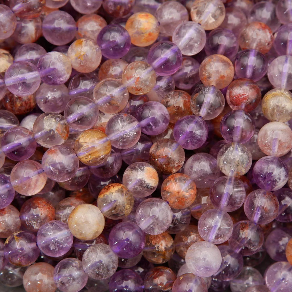 Close-up of multicolored beads with purple, orange, and white hues.