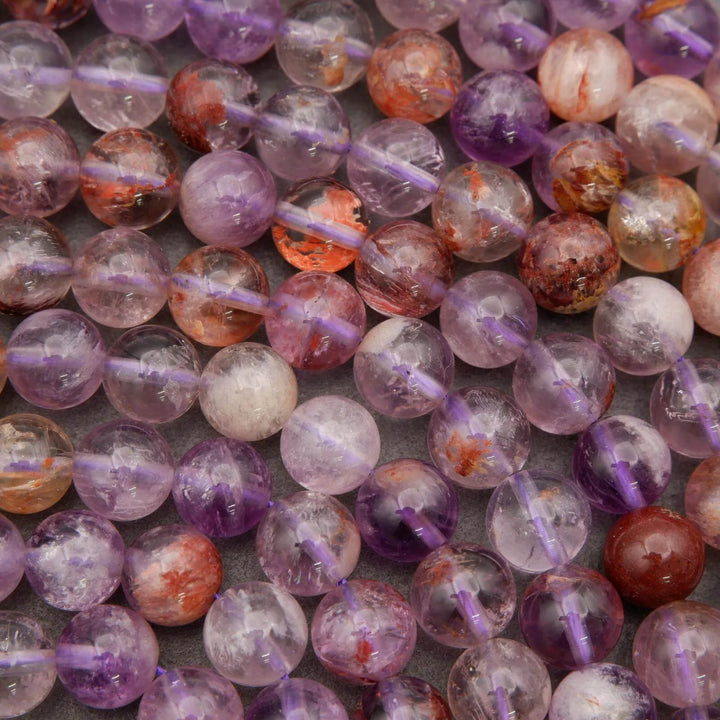 Close-up of multicolored beads on strings with a gray background