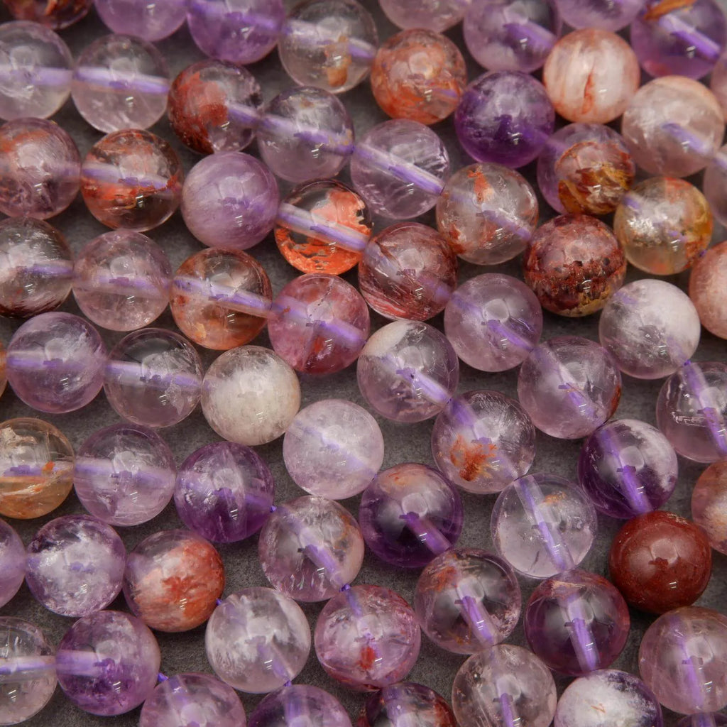 Close-up of multicolored beads on strings with a gray background