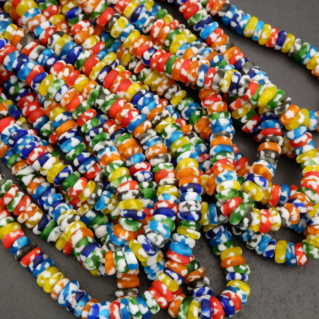 Colorful glass beads on a dark surface