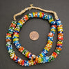 Colorful beaded necklace on a dark surface with a penny for scale