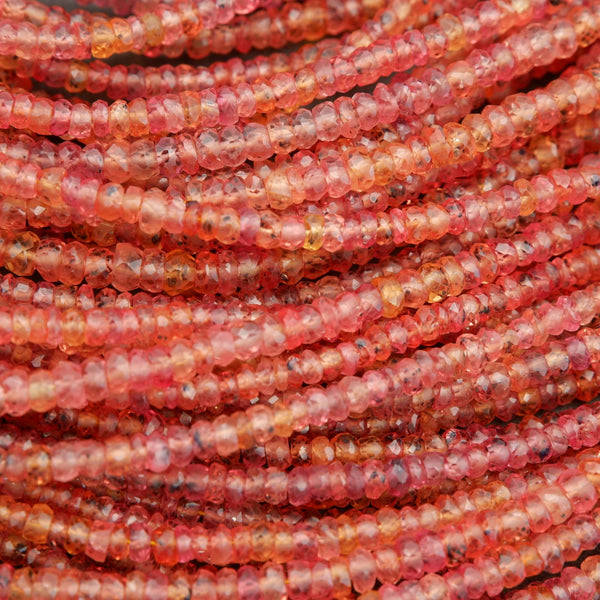 Close-up of pink and red glass beads on a string