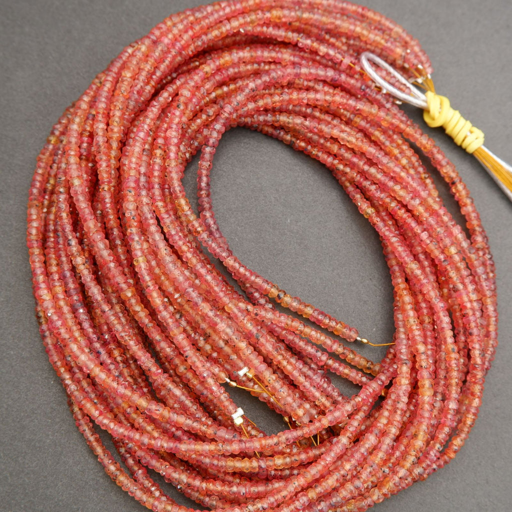 Coiled red beaded necklace on a gray background
