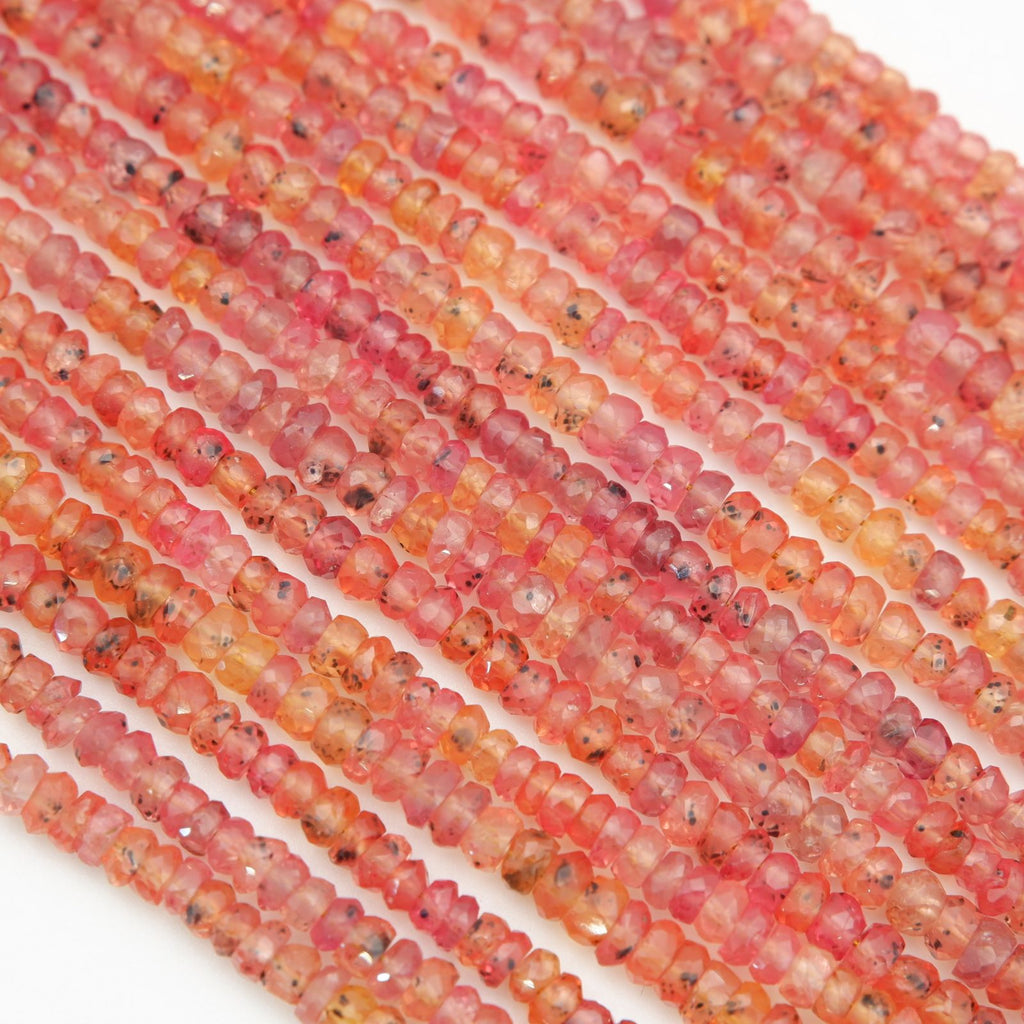 Close-up of red and orange glass beads on a white background