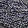 Close-up of purple faceted beads on a gray background
