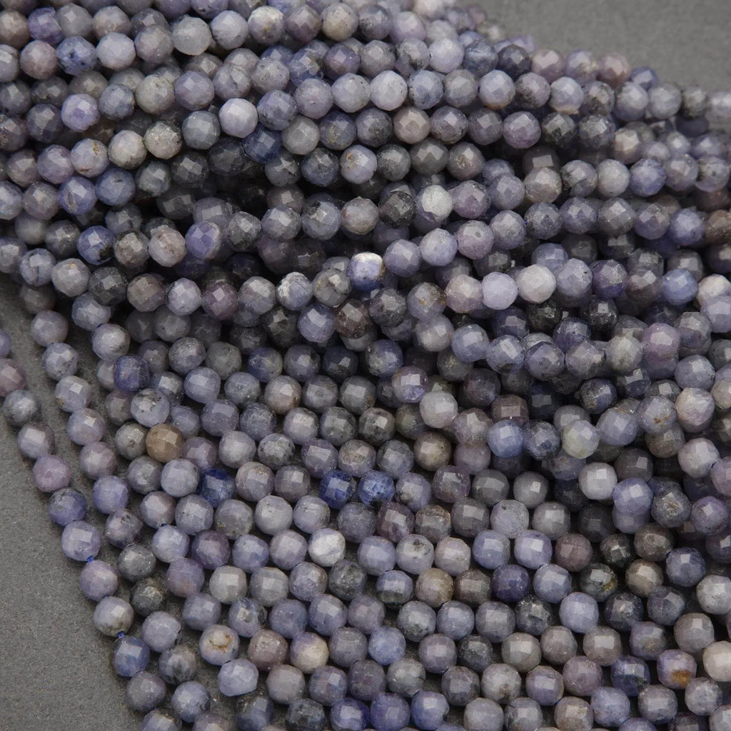 Close-up of purple faceted beads on a gray background