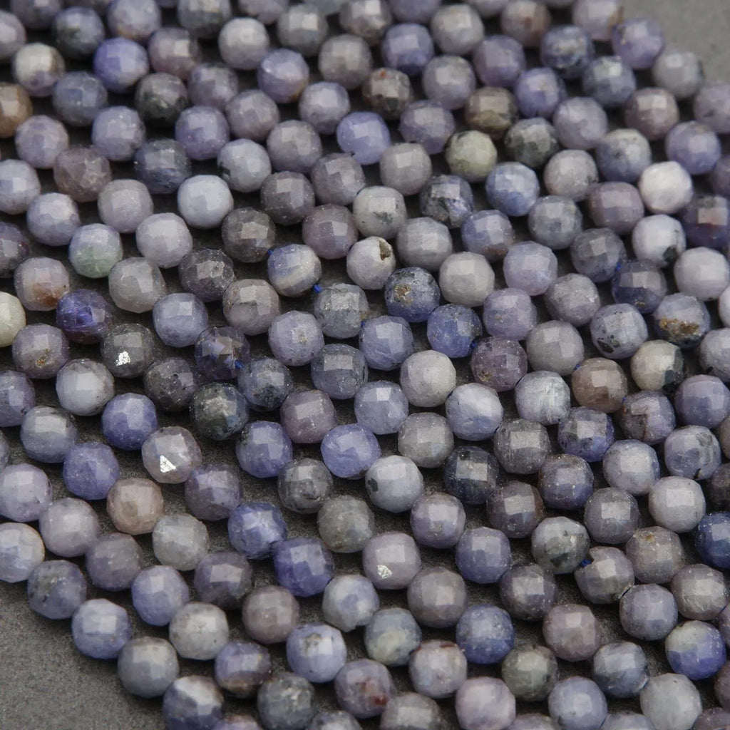 Close-up of purple and gray beads on a dark background