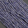 Close-up of purple beads on a dark surface