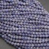 Close-up of purple beads on a dark surface