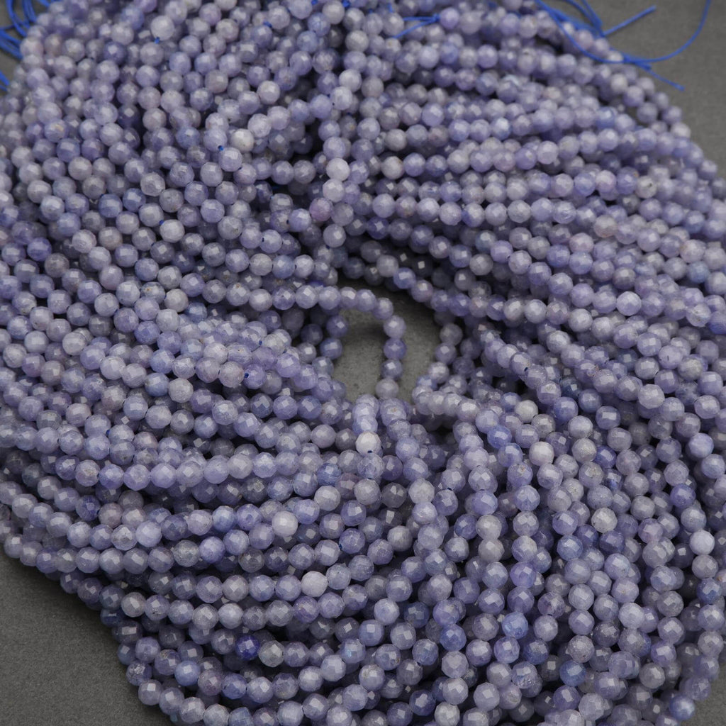 Close-up of a string of purple beads on a gray background