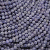 Close-up of purple beads with a dark background