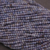 Close-up of a string of blue beads on a dark background