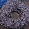 Coiled blue yarn on a dark surface