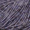 Close-up of purple beads with a textured surface
