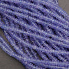 Close-up of a string of purple beads on a dark background