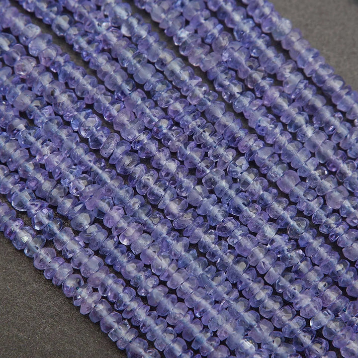 Close-up of a string of purple beads on a dark background