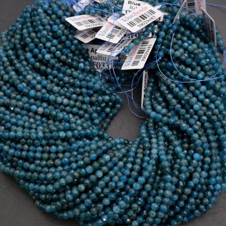 Blue beads with price tags on a dark surface