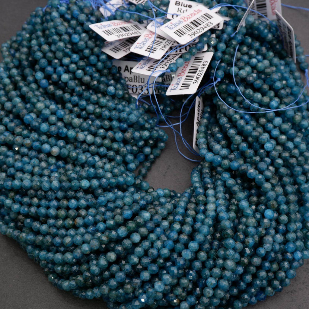 Blue beads with price tags on a dark surface