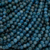 Close-up of blue beads with a dark background