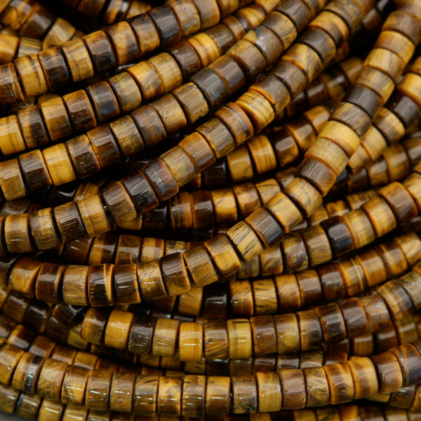 Macro image of tiger’s eye disc beads highlighting silky chatoyancy and natural mineral patterns.