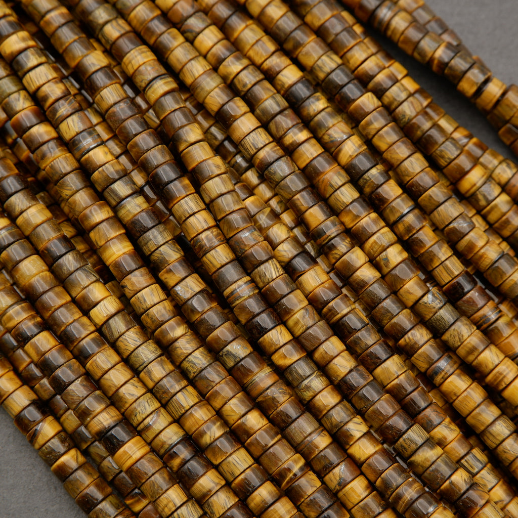 Bundle of tiger’s eye heishi bead strands showing varied golden brown striping and texture.