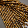 Assorted tiger’s eye heishi bead strands arranged in overlapping rows on a neutral background.