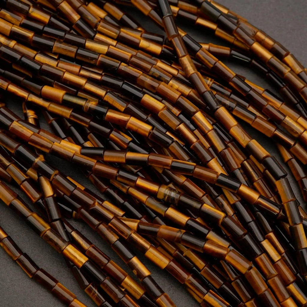 Close-up of dark brown and black cylindrical beads on a gray background
