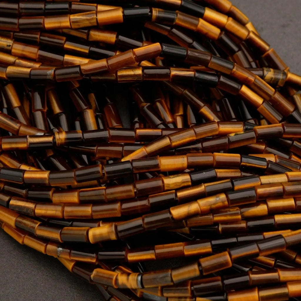 Close-up of brown and black cylindrical beads on a dark background