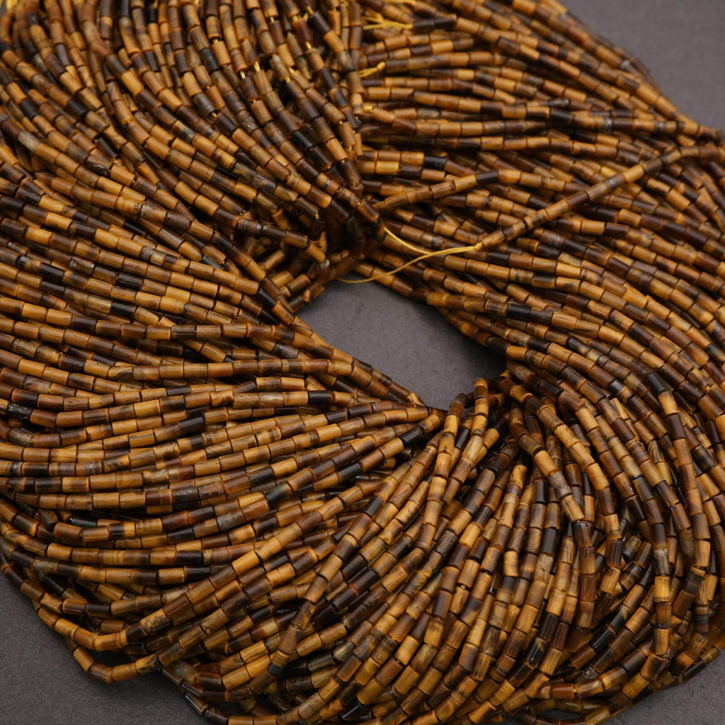Close-up of a coil of brown and black beads on a dark background