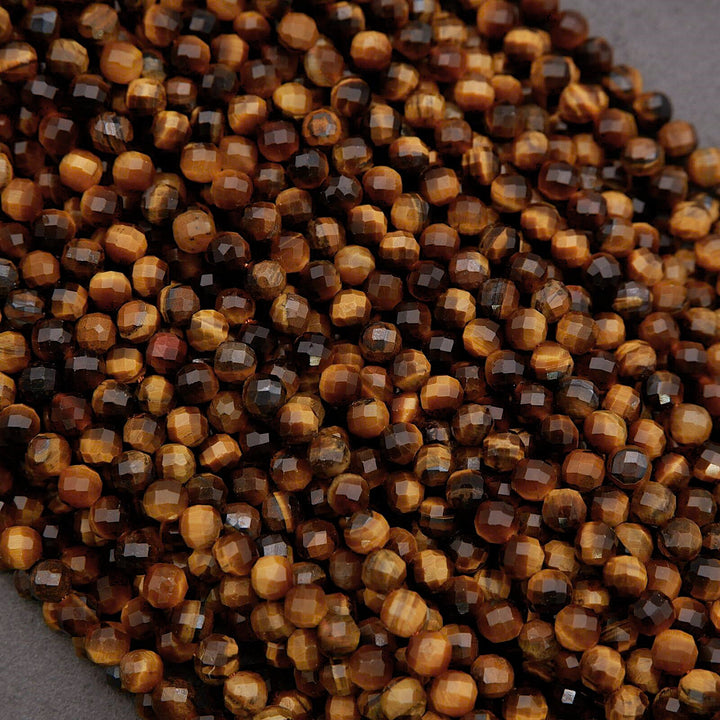 Close-up of brown and black faceted beads on a gray surface