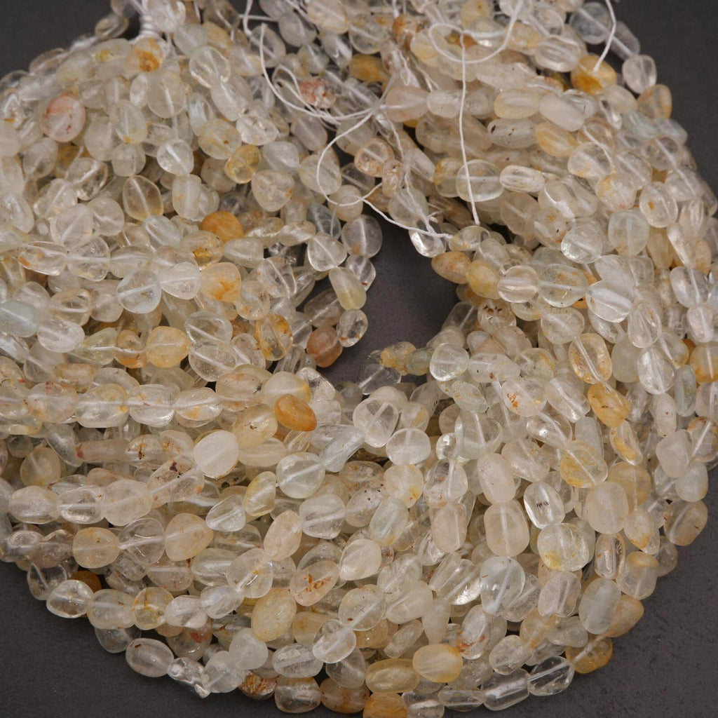 Close-up of a string of clear and amber-colored beads on a dark background