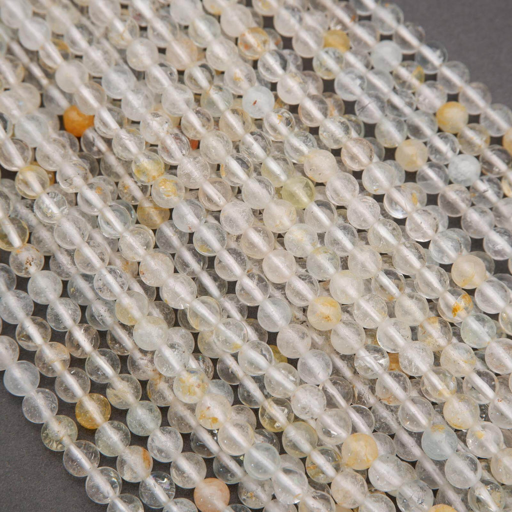 Close-up of clear and multicolored beads on a gray background