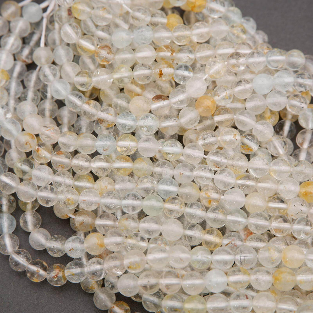Close-up of clear and yellow beads on a gray background
