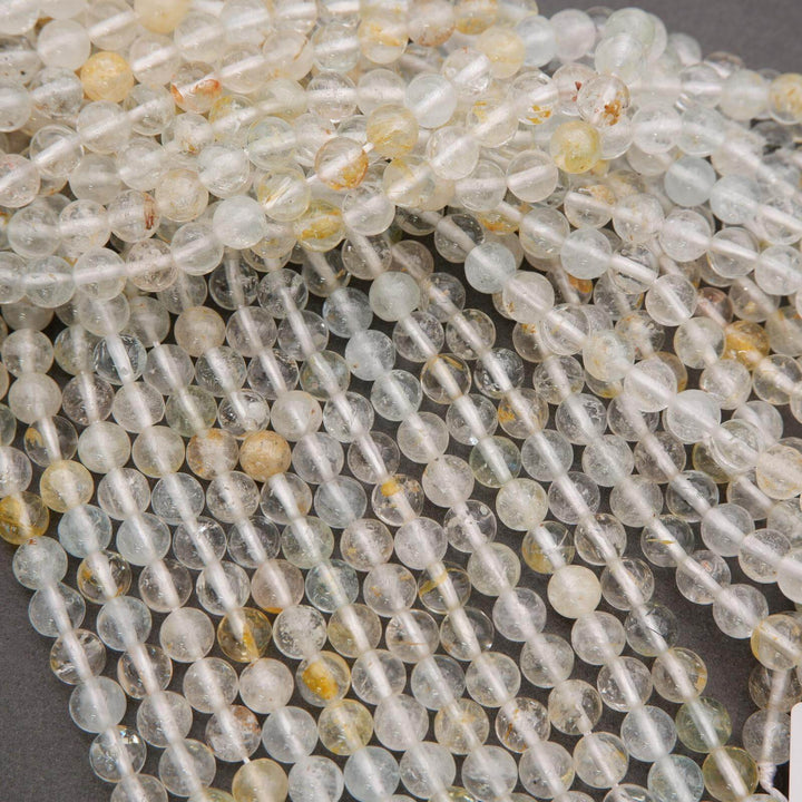 Close-up of clear and yellow beads on a gray background