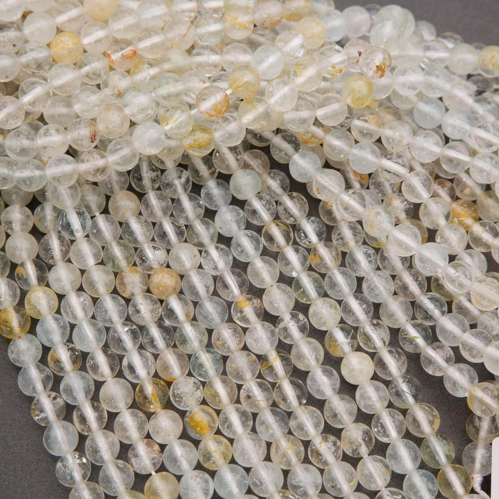 Close-up of clear and yellow beads on a gray background