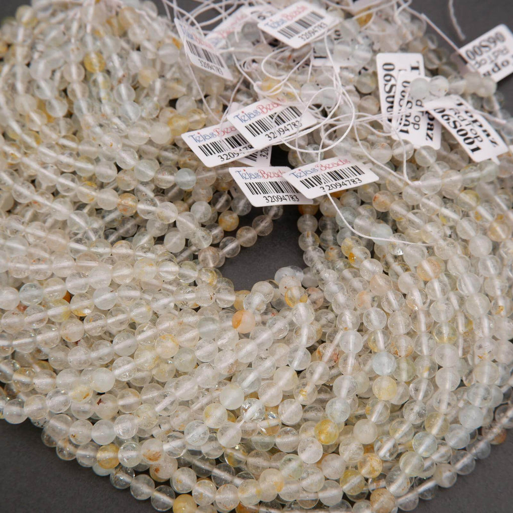 Close-up of a string of clear beads with small labels on a dark background