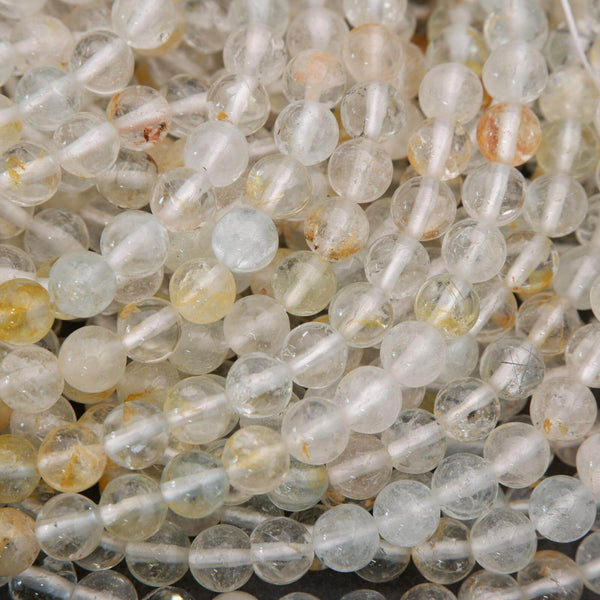 Close-up of clear and yellow beads on a dark background