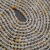 Close-up of a string of clear and multicolored beads.