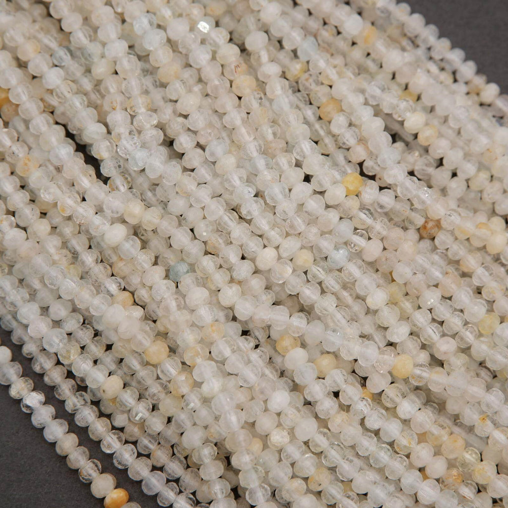 Microfaceted Rondelle Clear Beads With Yellow Inclusions.