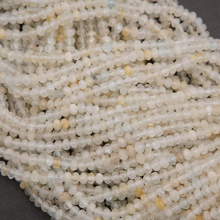 Microfaceted Rondelle Clear Beads With Yellow Inclusions.