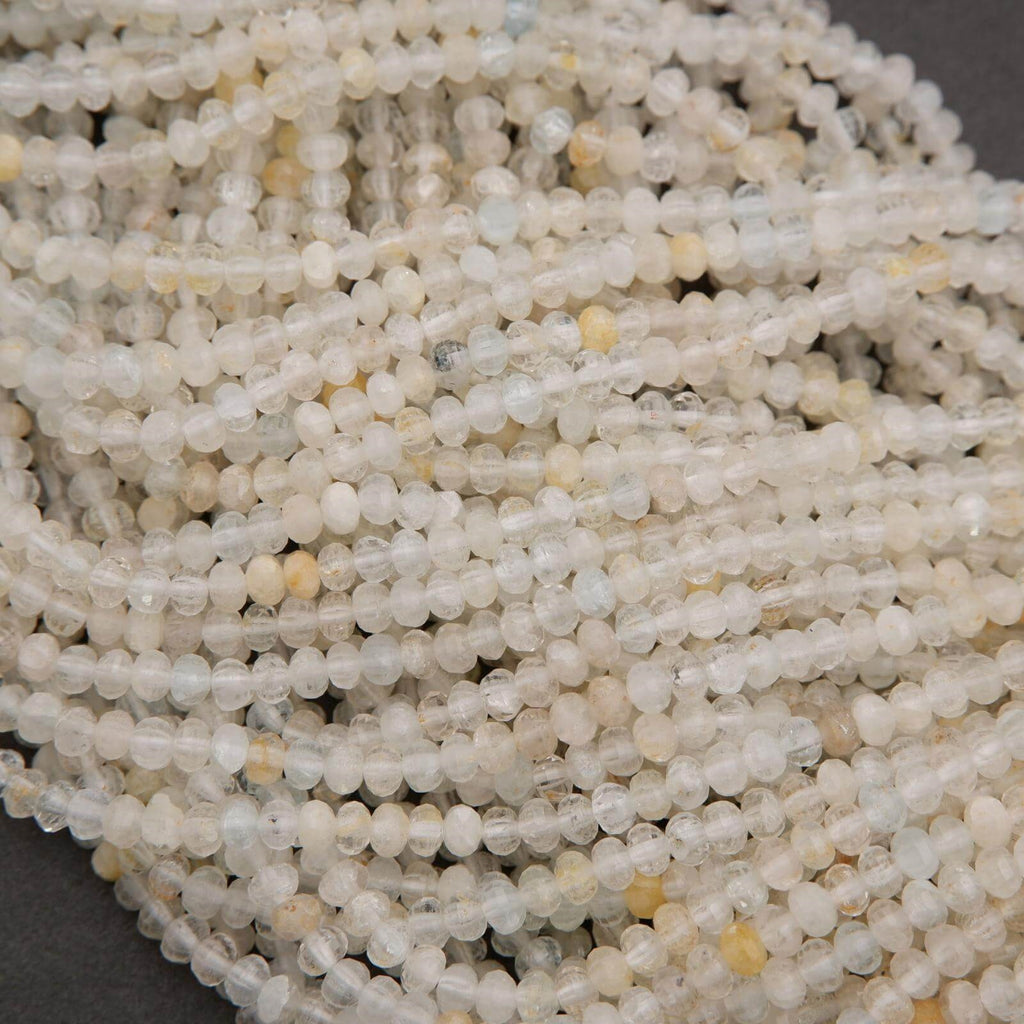 Microfaceted Rondelle Clear Beads With Yellow Inclusions.