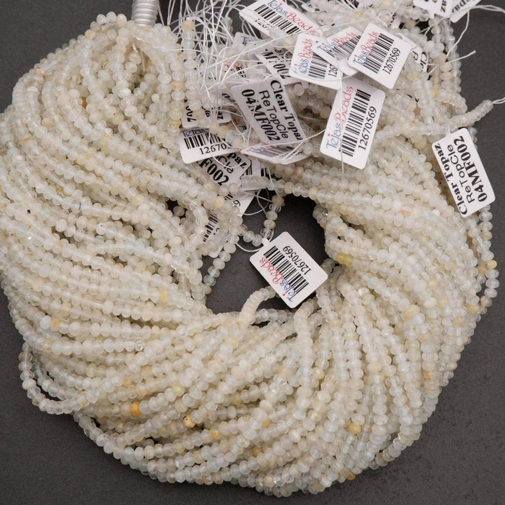 Microfaceted Rondelle Clear Beads With Yellow Inclusions.