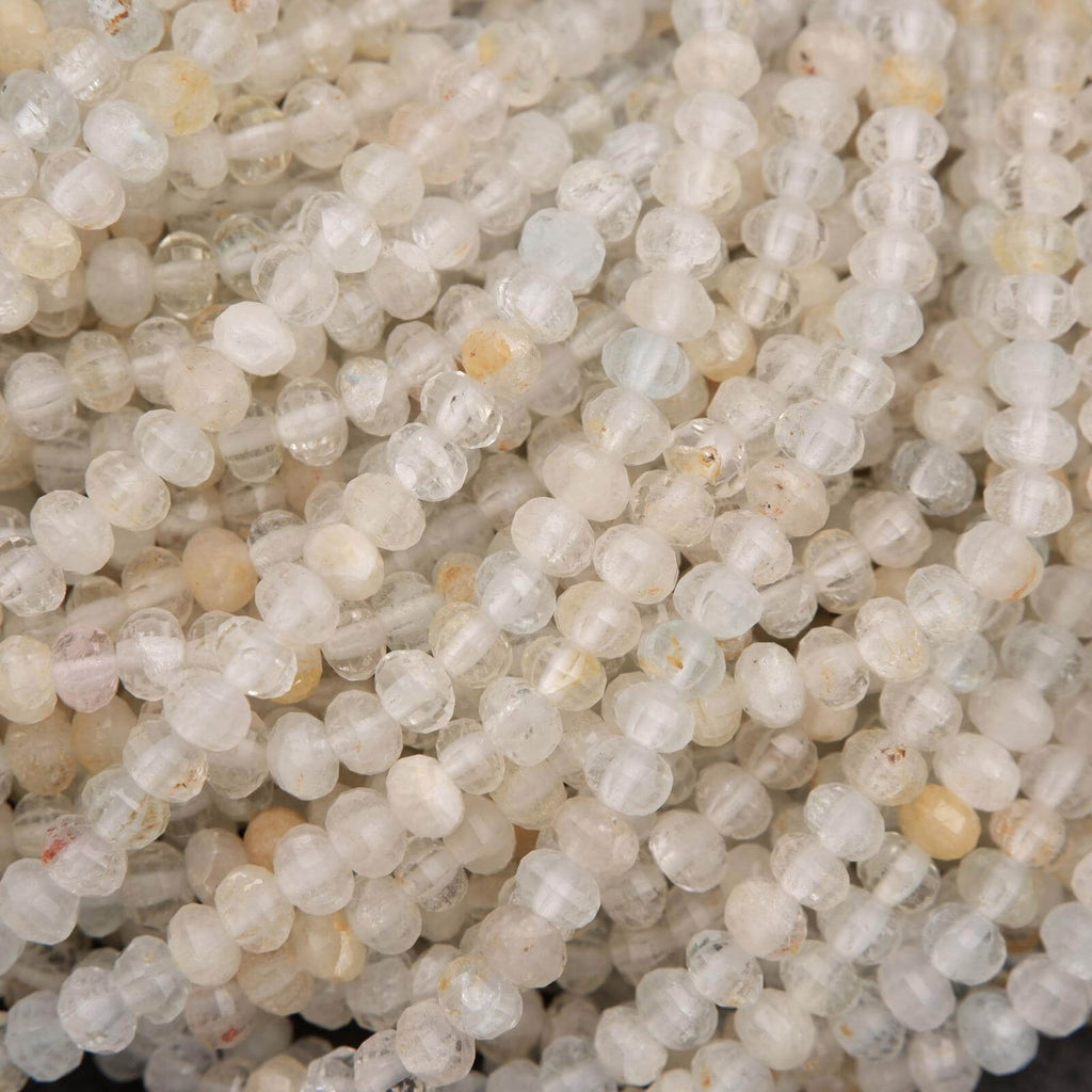 Microfaceted Rondelle Clear Beads With Yellow Inclusions.