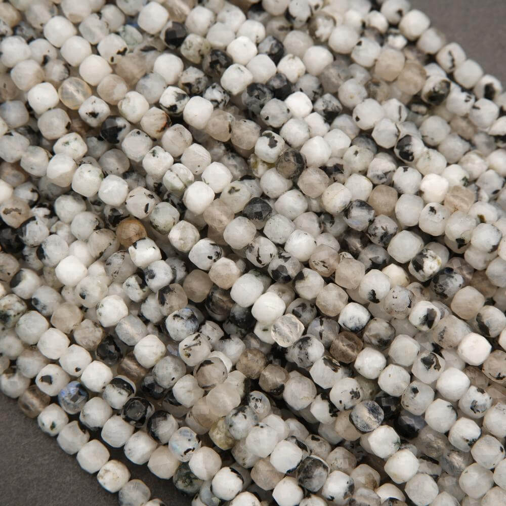 Close-up of small white and black beads on a string
