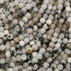Close-up of small, round beads in various neutral colors.