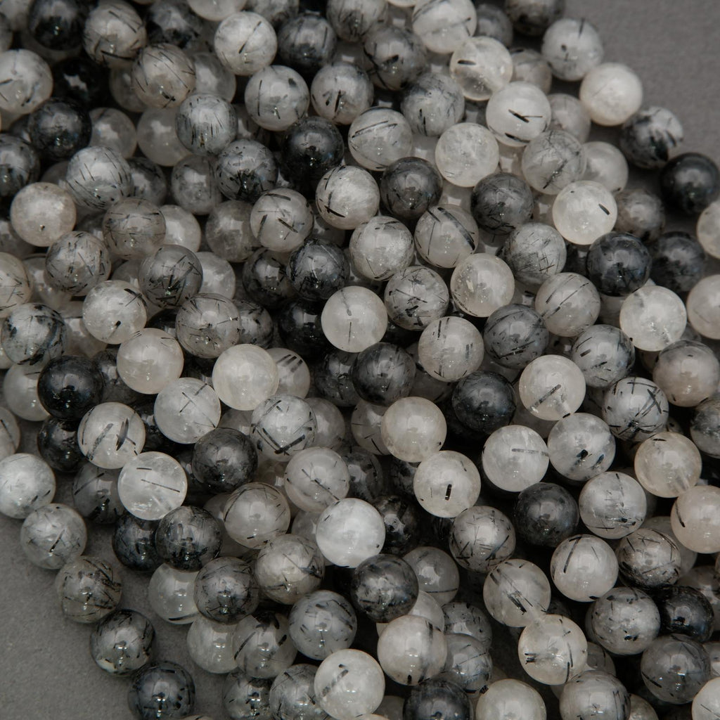 Natural tourmalated quartz gemstone beads showing black needle inclusions