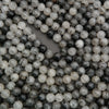 Detailed view of tourmalated quartz round beads with contrasting black needles